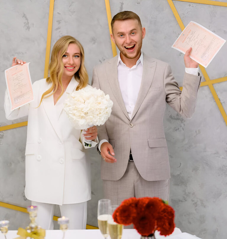 happy-attractive-married-young-man-woman-holding-wedding-license-smiling-wedding-day-ceremony-cute-blonde-bride-woman-wears-stylish-white-wedding-suit-family-celebration_8353-12567